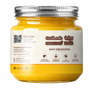 A glass jar of yellow ghee with a silver metal lid and a white label featuring text in English and Devanagari script, set against a plain white background.