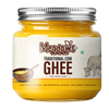A jar of Meadows Traditional Cow Ghee on a solid white background. The product is in a clear glass jar filled with golden yellow ghee, topped with a silver metal screw lid, and wrapped in a white label with brown and green text.
